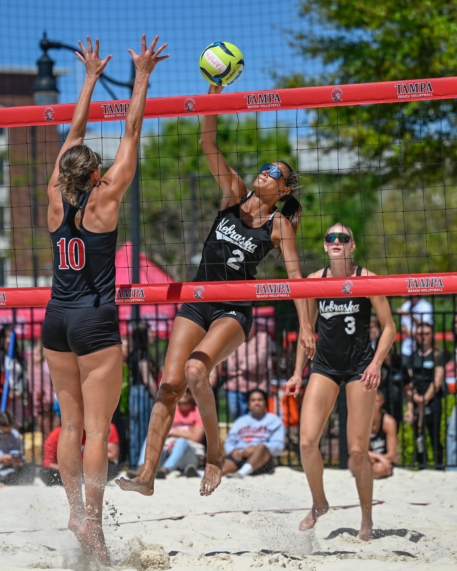 Beach volleyball athlete attacking at the net in Tampa