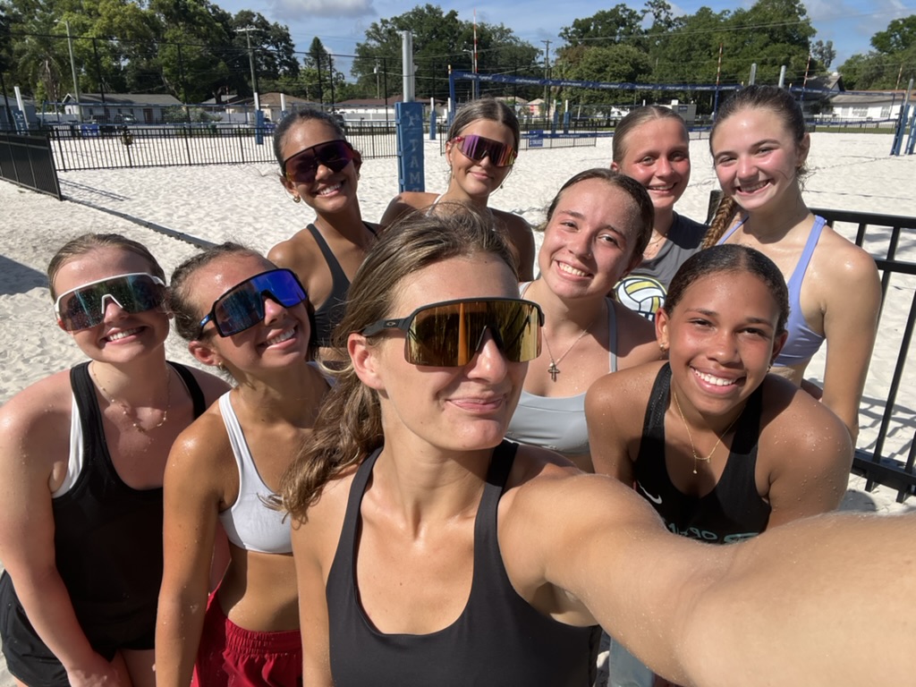 Athletes and coaches smiling together at a Beach Break clinic