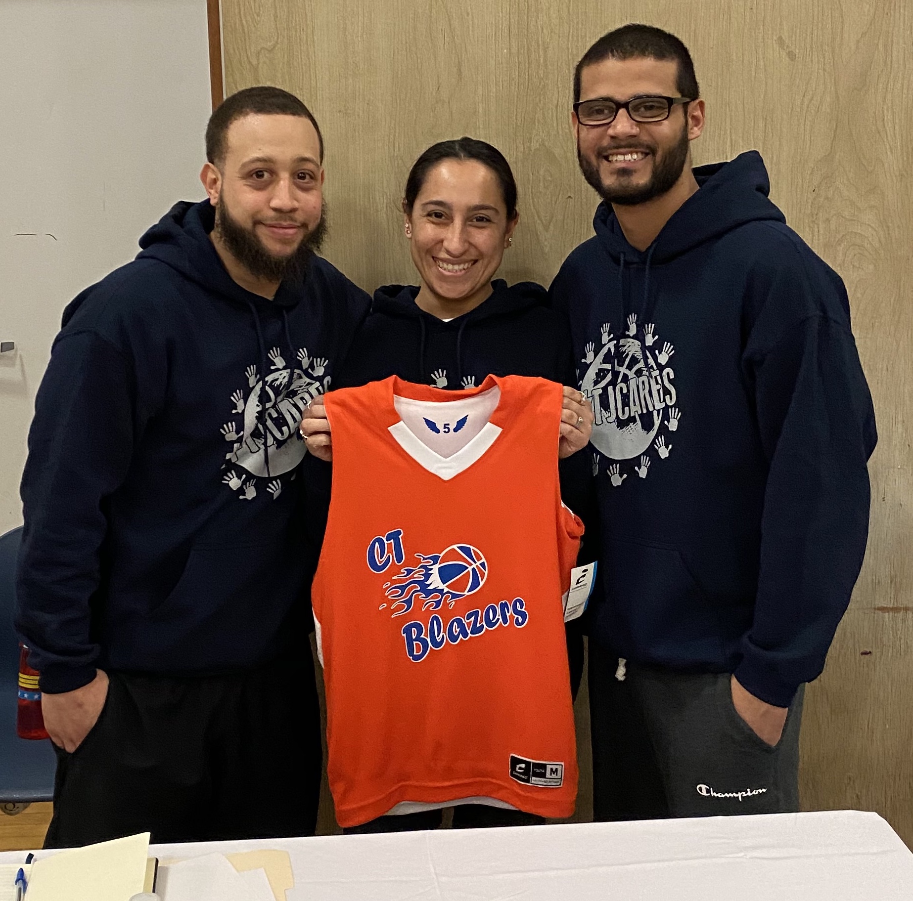 CT Blazers coaches with a team jersey at a #TJCARES event