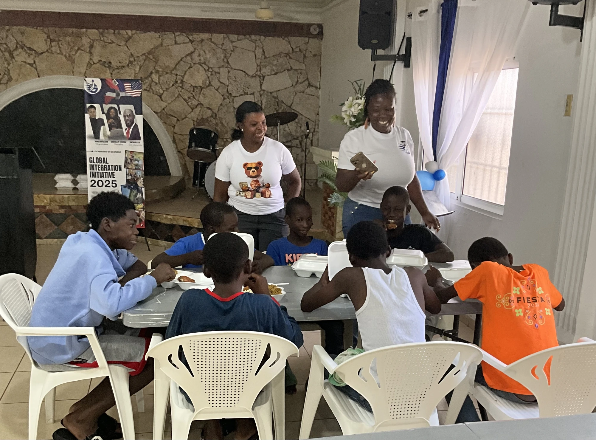 Children sharing a meal together during a project event