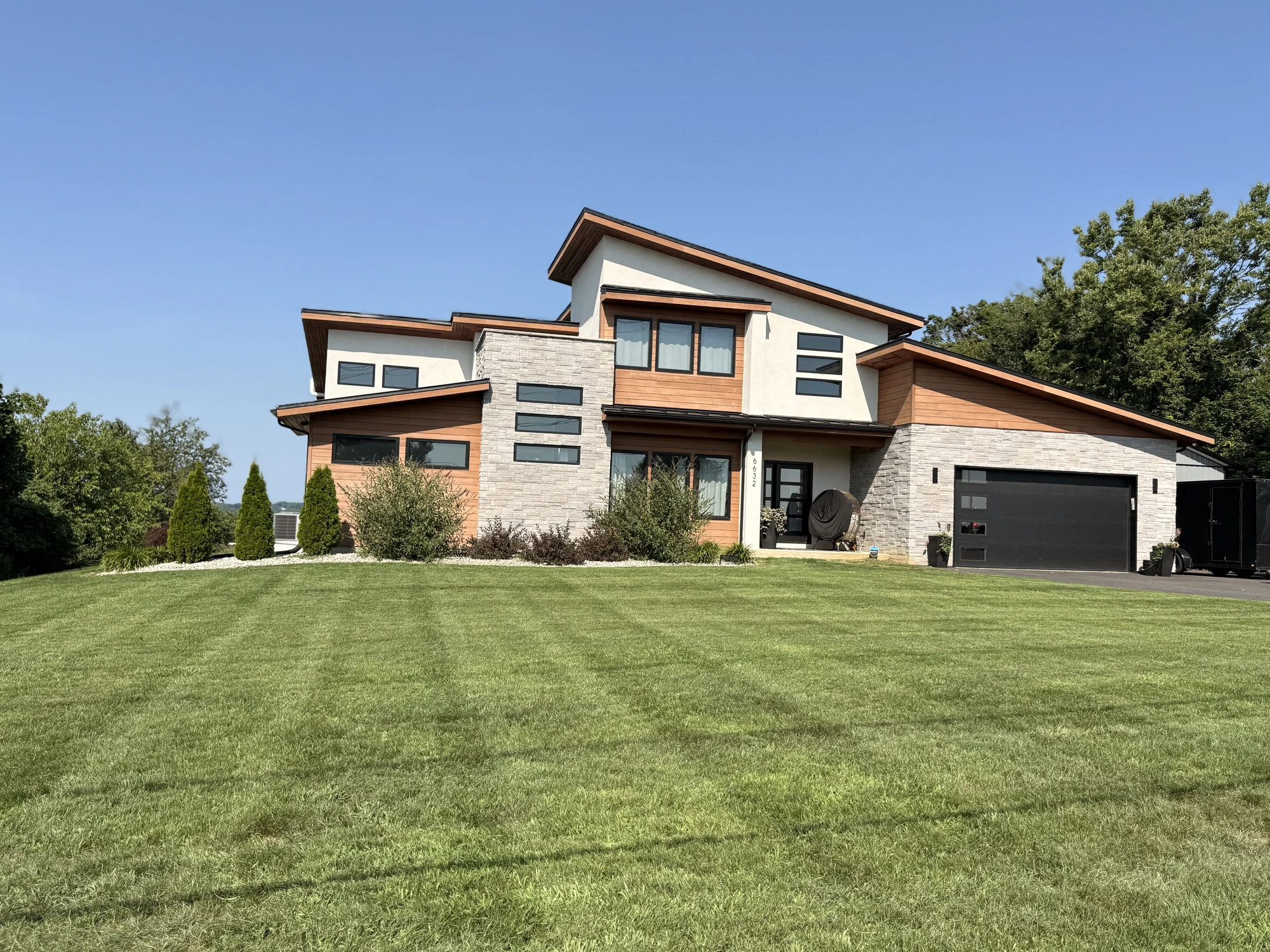 Manicured front lawn with elegant home