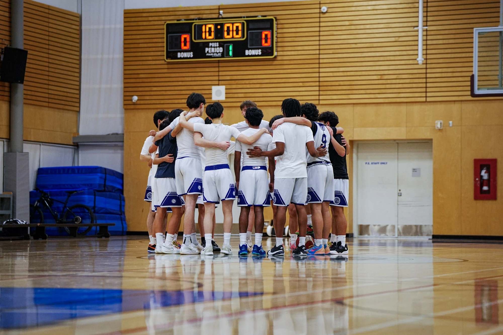 Coach Elete's team in a huddle