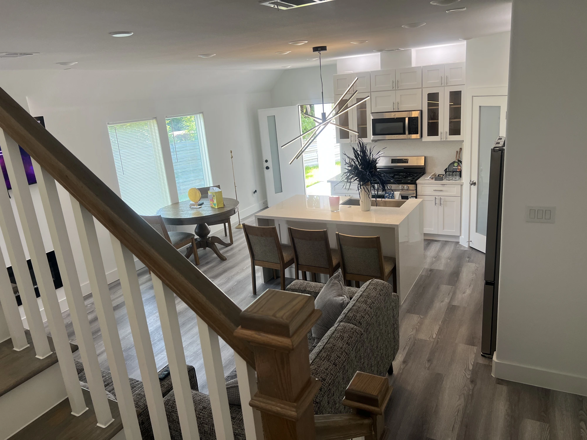 View of kitchen and dining from staircase