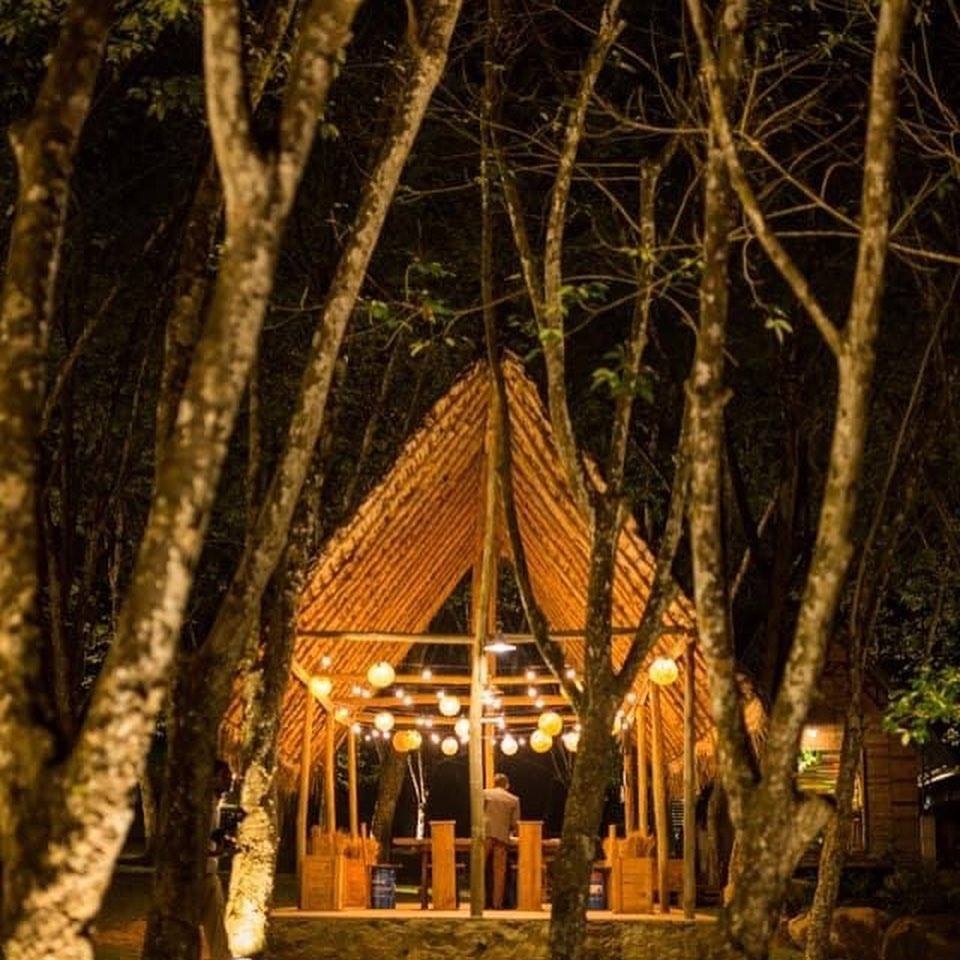 The Barn pavilion glowing with string lights at night
